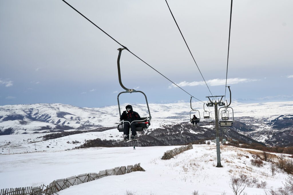 skiers riding lift chair skiing season armenia tsaghkadzor